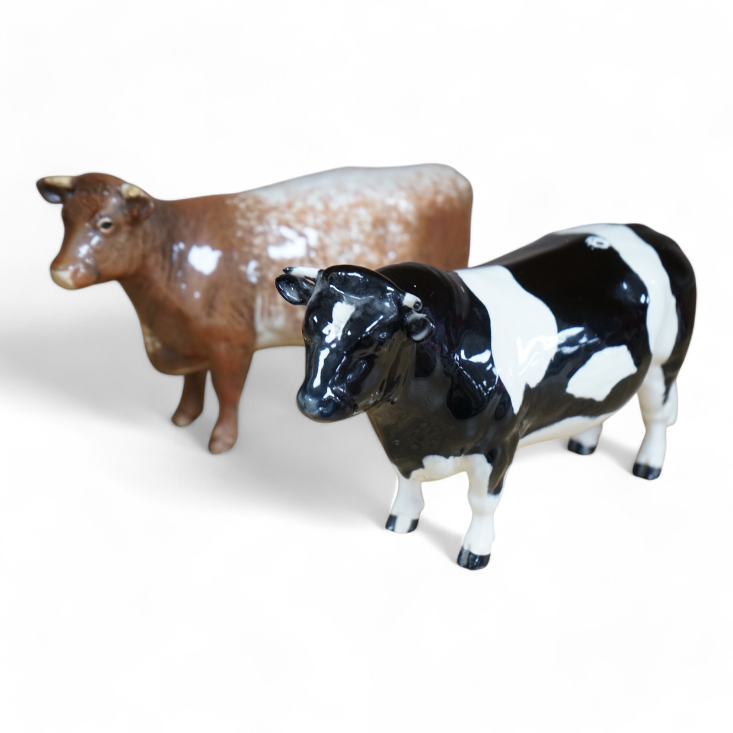 A Beswick model of a Shorthorn cow, ch. ''Eaton Wild Eyes 91st'', together with a Beswick Coddington Hilt Bar bull, 20cm. Condition - good